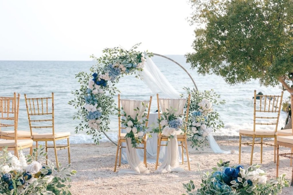     Beach wedding near Manila with elegant dusty blue and white floral ceremony setup